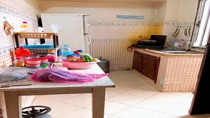 A small kitchen with a gas stove, a sink, and a table with various items on it. - Sweet sleep (Casablanca)