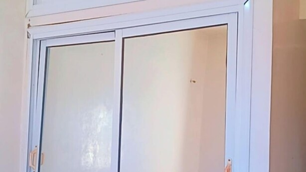 A room with a large wardrobe featuring a sliding door and a bed with a blue blanket. - Sweet sleep (Casablanca)