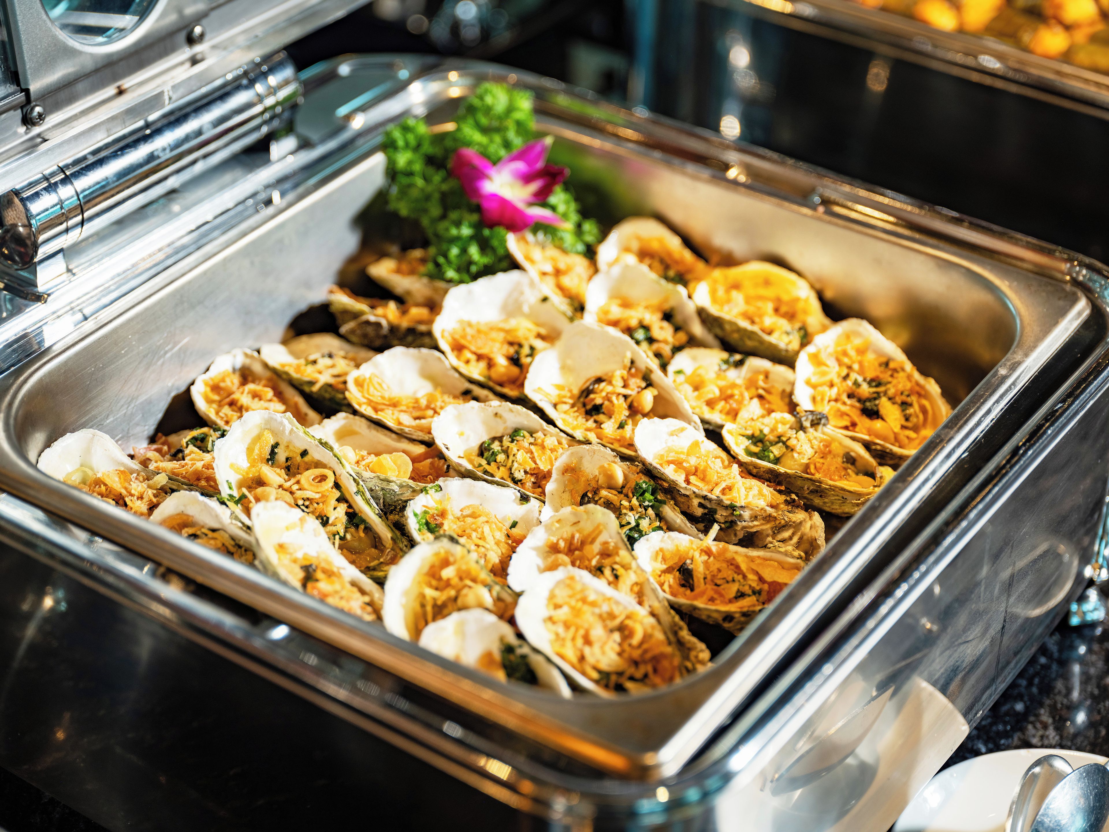 A buffet with oysters and other seafood dishes.