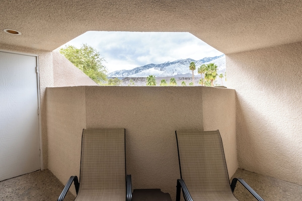 Sip coffee on the balcony with scenic mountain views.