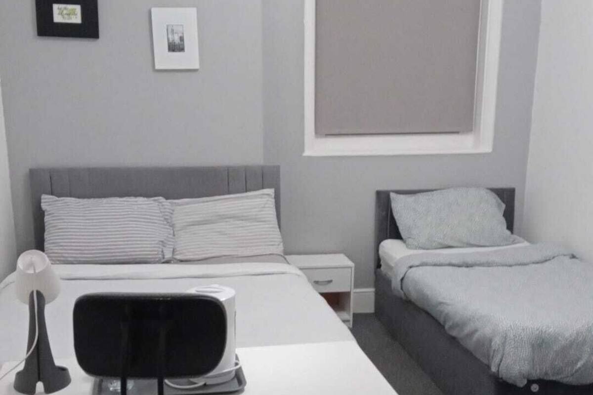 Family Triple Room, Non Smoking, Private Bathroom | Desk, laptop workspace, blackout drapes, iron/ironing board