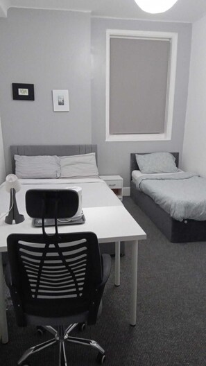 Family Triple Room, Non Smoking, Private Bathroom | Desk, laptop workspace, blackout drapes, iron/ironing board