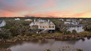 A large waterfront property with multiple houses, a dock, and a lake.