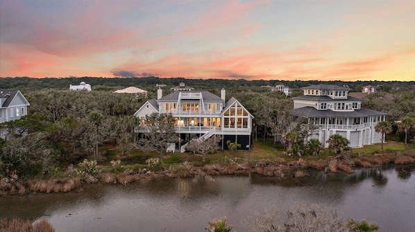 A large waterfront property with multiple houses, a dock, and a lake. - Luxury 5BR Oceanview ~ Chiltren By the Sea (Edisto Island)