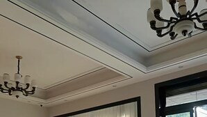 A spacious room with a large window, a dining area with a wooden table and chairs, and a chandelier. - Wangxian Valley Morning Wind B&B - Wangxian Valley Scenic Area (Shangrao)