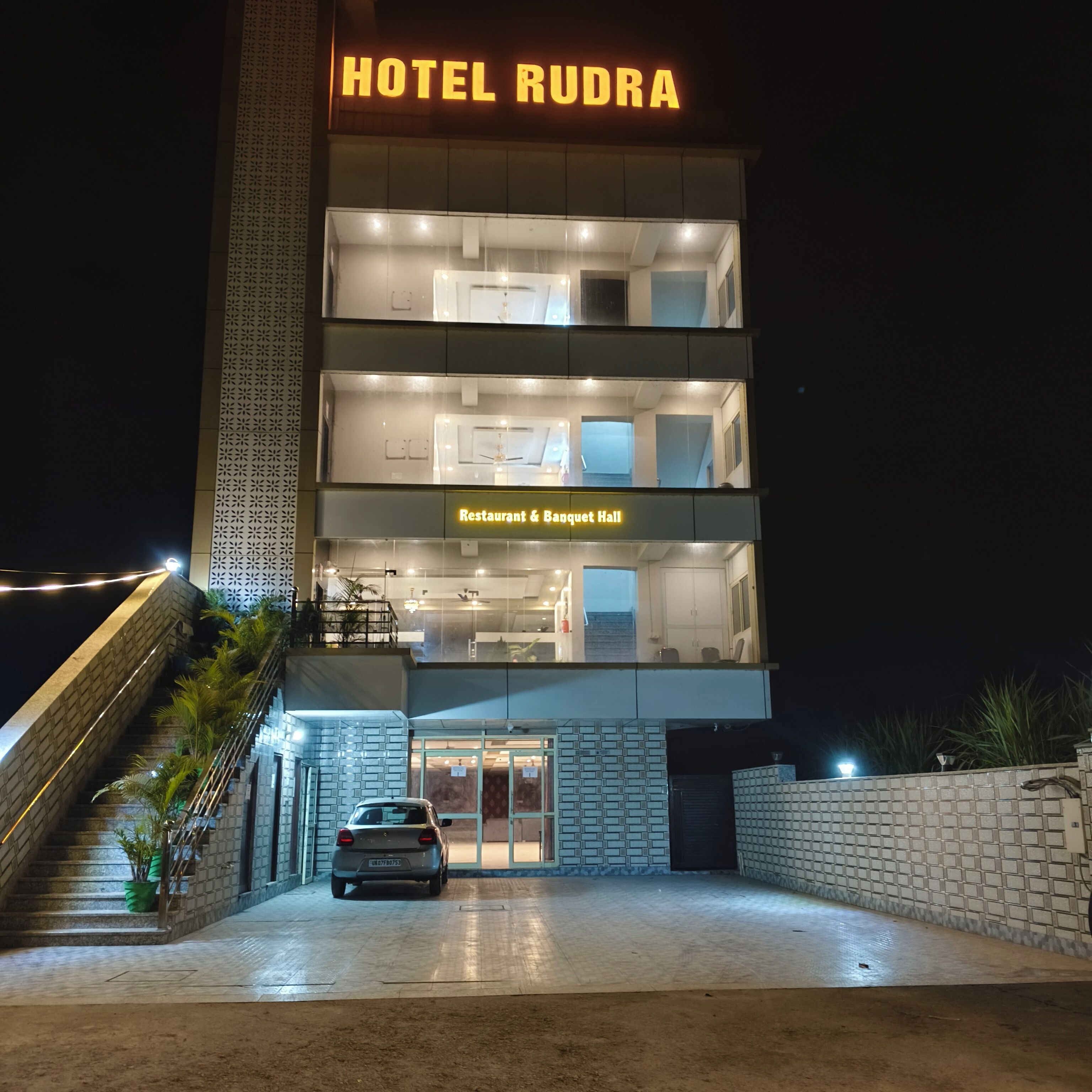 A multi-story hotel with a visible restaurant and banquet hall on the ground floor.