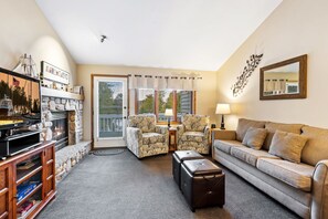 TV, fireplace - Welcoming 2-bedroom condo featuring an updated walk-in shower. (Fish Creek)