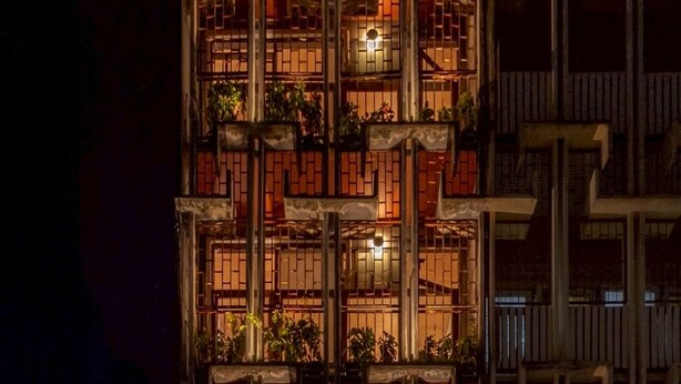 A multi-story building with a traditional architectural style, featuring a series of balconies and windows.