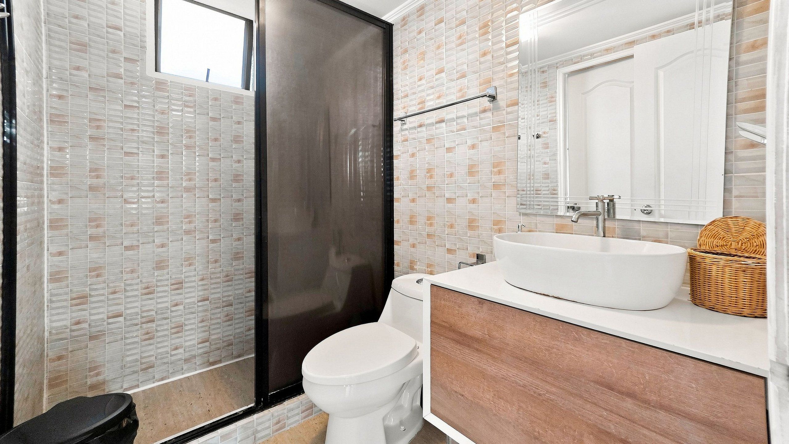 A bathroom with a shower, toilet, and sink.