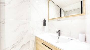 Shower, hair dryer, towels, toilet paper
