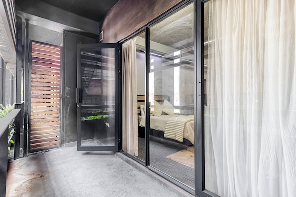 A modern interior with a sliding glass door leading to a bedroom.