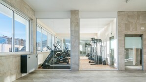 A spacious gym with exercise equipment, large windows, and a modern architectural design. - CourtView Modern Lagos Apartment (Lagos)