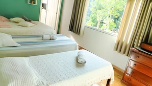A hotel room with two beds, a wooden dresser, and a window with curtains. - Oceana Suites Ponto Alto (Domingos Martins)