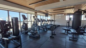 A gym with treadmills, weight machines, and free weights.