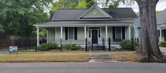 Lovely fenced and gated 3-bed/ 2 bath home on beautiful Elm lined Main Street.