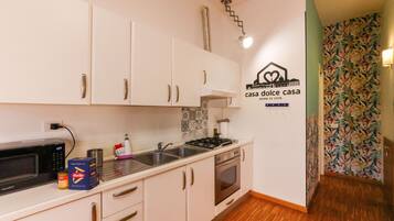 Apartment | Private kitchen | Fridge, microwave, stovetop, cookware/dishes/utensils