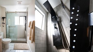 A bathroom with a glass shower enclosure, a toilet, and a towel rack. - Stylish Downtown Apt - Workspace + Games + Parking (Dallas)