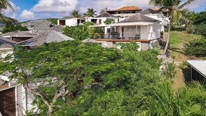 A residential area with houses, a pool, and lush greenery.