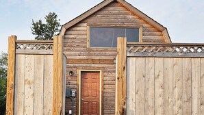 A wooden cabin with a front door, a window, and a staircase leading to the entrance. - Cabin with Private HOT TUB!!!  8 minutes to Ark Encounter!!! (Dry Ridge)