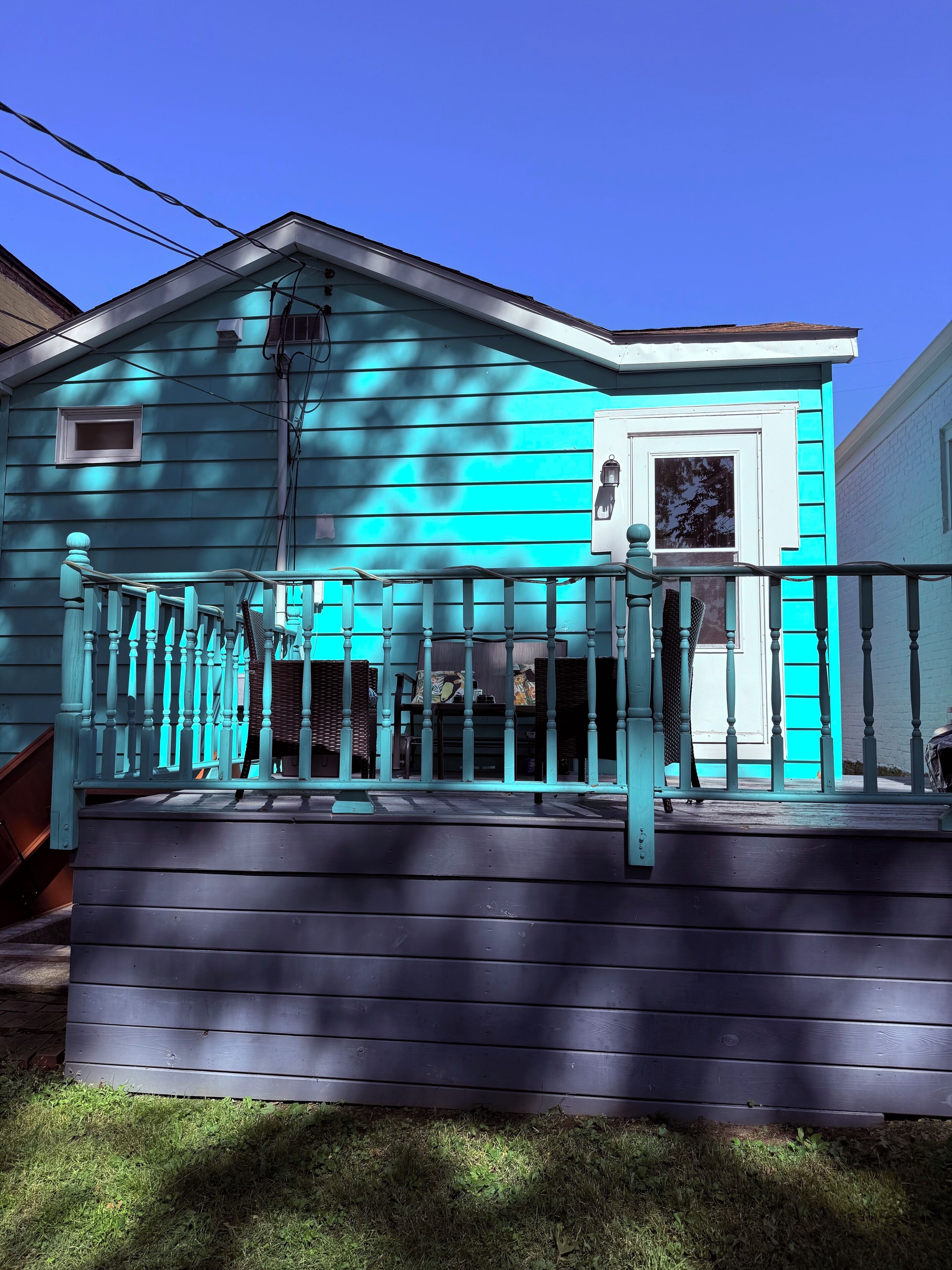 A house with a porch, a small window, and a door.