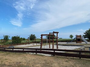 A playground with swings, a slide, and climbing structures.