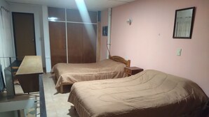 A bedroom with two beds, a desk, and a wardrobe. - The House of Napoli (Trelew)