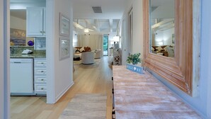 A modern interior with a kitchen, dining area, and living room. - Hilton Head Retreat | Gated Villa, Pets OK (Hilton Head Island)