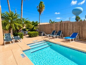 A swimming pool with lounge chairs and palm trees. - Paradise Bay 8 - Two Bedroom Off The Beach (South Padre Island)