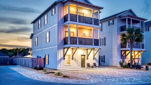 A two-story house with a balcony, a driveway, and a small vehicle parked outside. - exhale: Private heated pool, Free golf cart, 2 mins to beach, Bunk Rooms (Miramar Beach)
