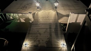 A wooden deck with two lantern-style lights at the end, leading to a higher platform. - Orlando Lakefront Pool Home, 25 min from Disney & Universal, 15 min from Airport (Orlando)