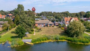 A residential area with houses, a dock, and a body of water.