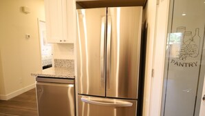 A stainless steel refrigerator in a kitchen with a granite countertop and a dishwasher. - 2-bedroom guesthouse in Riverside. Centrally located near CBU,Parkview and 91fwy (Riverside)