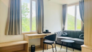 A modern room with a desk, chair, sofa, and a small table. - Dhairya Garh  (Udaipur)
