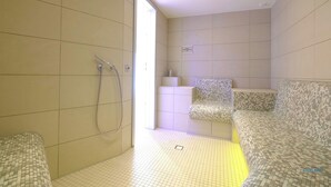 A modern bathroom with a shower, a seating area, and a tiled floor. - Vacation apartment Watt`n Blick 220: Comfortable vacation right on the beach in Cuxhaven (Cuxhaven)