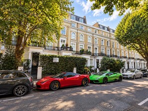 A street lined with classic terraced houses, parked cars, and trees. - London Style (5) Apartment (Greater London)