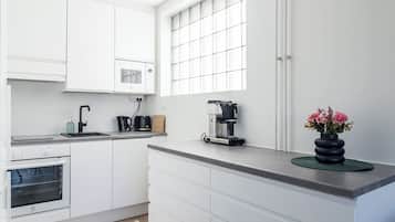 Deluxe Apartment, Balcony | Private kitchen | Coffee/tea maker, toaster, spices, cleaning supplies