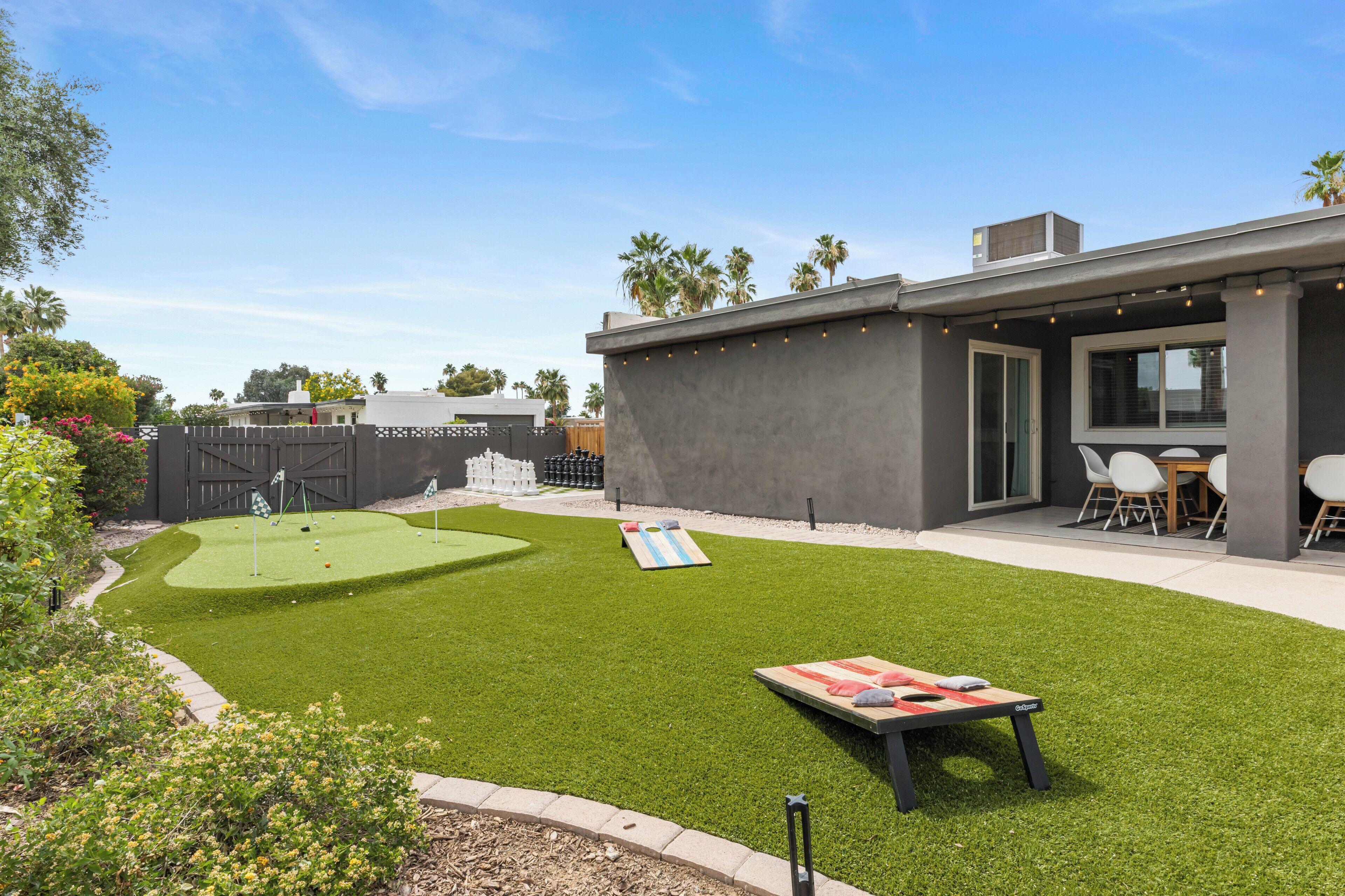A modern patio with a flat surface, a small table, and a seating area with chairs.