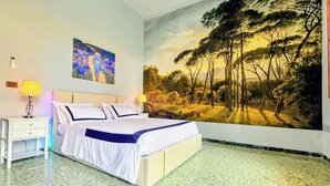 A bedroom with a bed, two bedside tables, a nightstand, a painting, and a mural. - Leonardo House Pisa Garden Center Whirlpool Pool (Pisa)