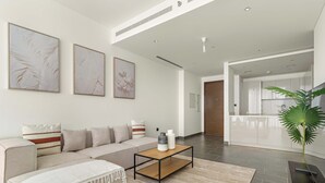 A modern living room with a sofa, coffee table, and artwork on the wall.