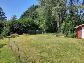 A grassy area with two soccer goals and a small shed. - 5 Person Holiday Home in Eskebjerg (Eskebjerg)