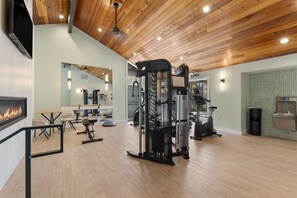 A spacious gym with various exercise equipment, a mirror, and a fireplace. - Steps from Lake Dillon & Amphitheater - Central to 3 World-Class Ski Resorts! (Dillon)