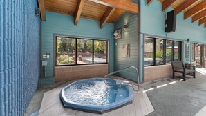 A hot tub area with a wooden ceiling, large windows, and a bench. - Modern Mountain-View Condo - Pool, Hot Tubs & Near 3 Ski Resorts! (Frisco)