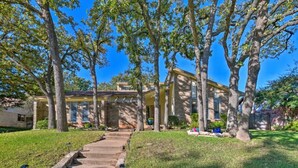 A two-story house with a stone facade, a front porch, and a well-maintained lawn. - 3 Bedroom with a Pool (Bedford)