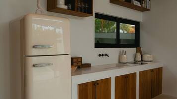 Fridge, toaster, cookware/dishes/utensils, dining tables