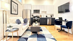 A modern apartment with a living room, kitchen, and dining area. - Downtown 1BR Retreat – Walk to PPAC – Kitchen & W/D (Providence)