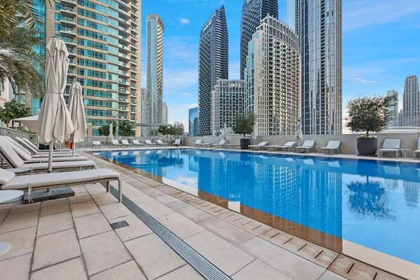 Outdoor pool, open 6:00 AM to 10:00 PM, pool umbrellas, pool loungers