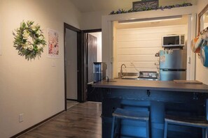 Fridge, microwave, coffee/tea maker, cookware/dishes/utensils