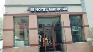 A hotel entrance with a sign reading "HOTEL AMBROSIA".