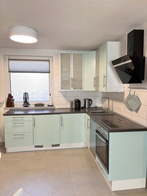 Fridge, stovetop, dishwasher, coffee/tea maker