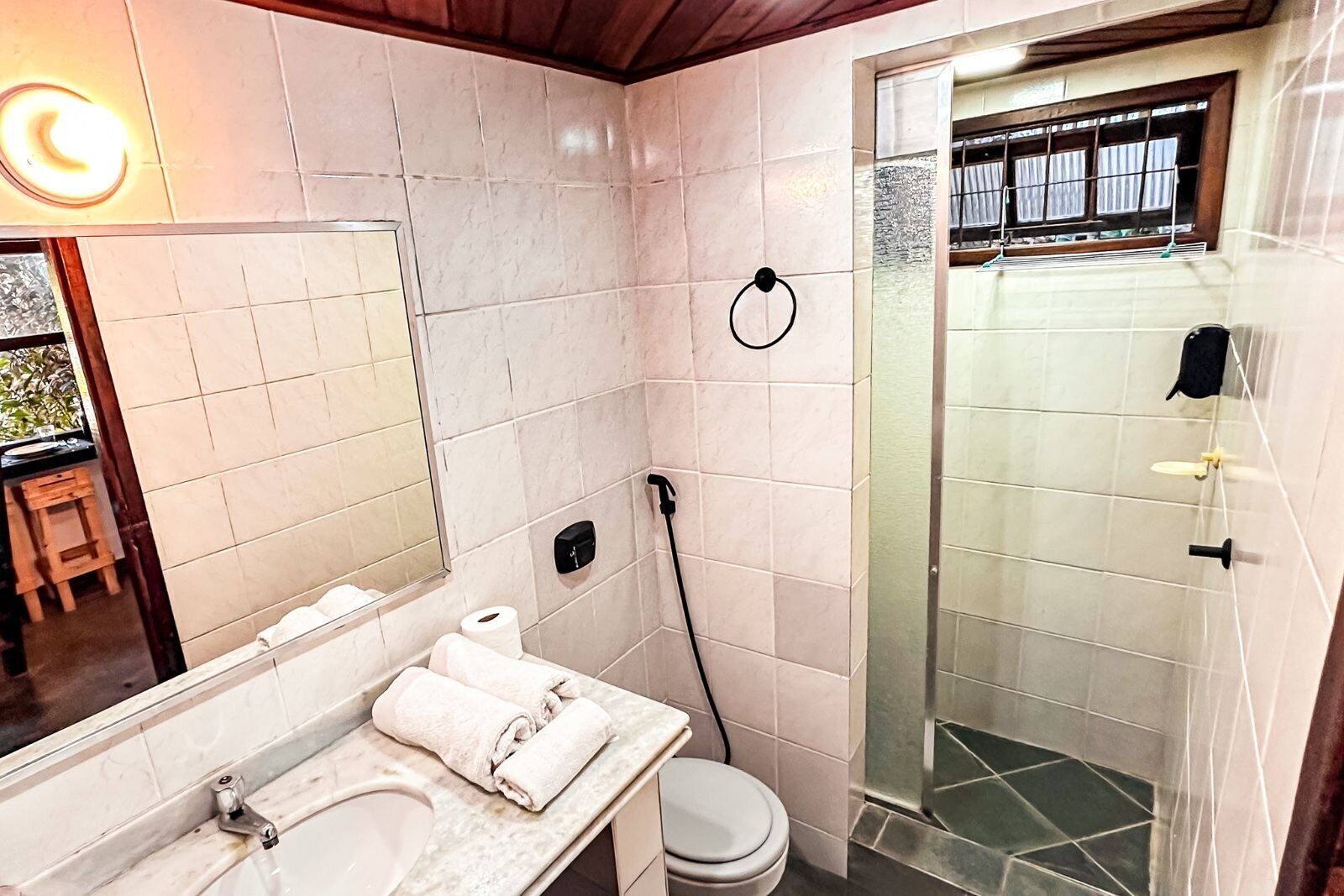 A bathroom with a sink, toilet, and shower.